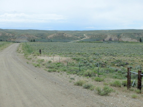 GDMBR: Buckskin Crossing lies ahead, the Big Sandy River is just out of view in this valley, and this road in the picture is over the actual Oregon and California Trail.